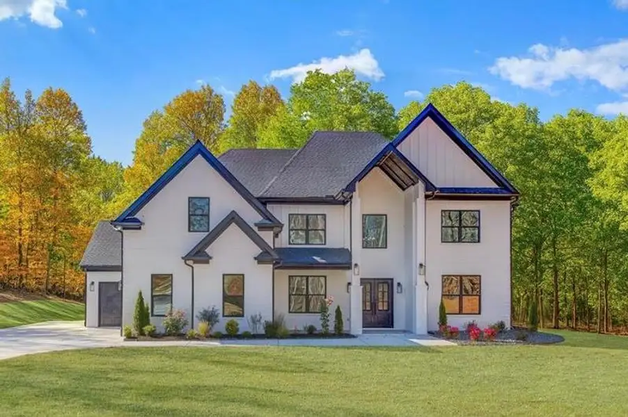 Front exterior of a new home in , Hoschton, GA, highlighting curb appeal (Image 1).