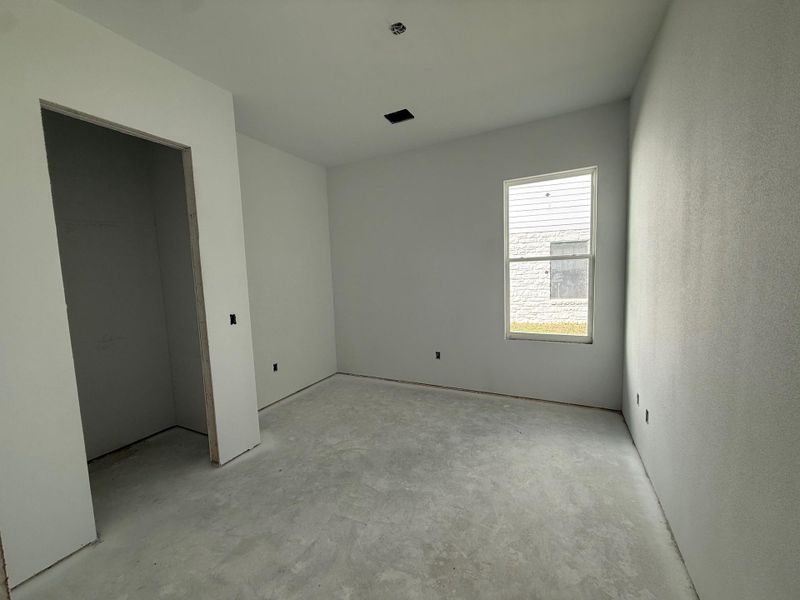 Unfurnished bedroom with concrete floors