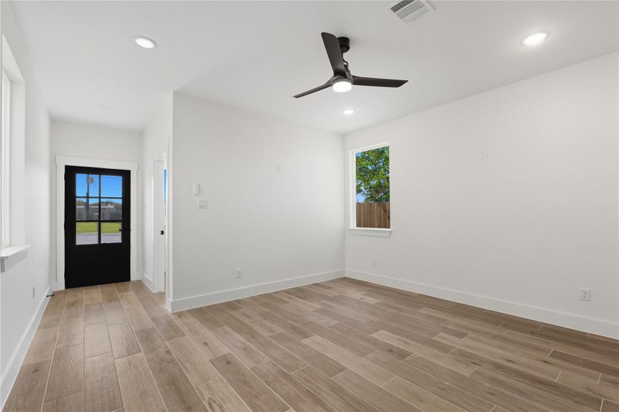Heres another look at the entrance and living space. The sleek black front door adds a stylish focal point, while the open layout creates a seamless flow into the rest of the home. Perfectly designed for both comfort and entertaining.
