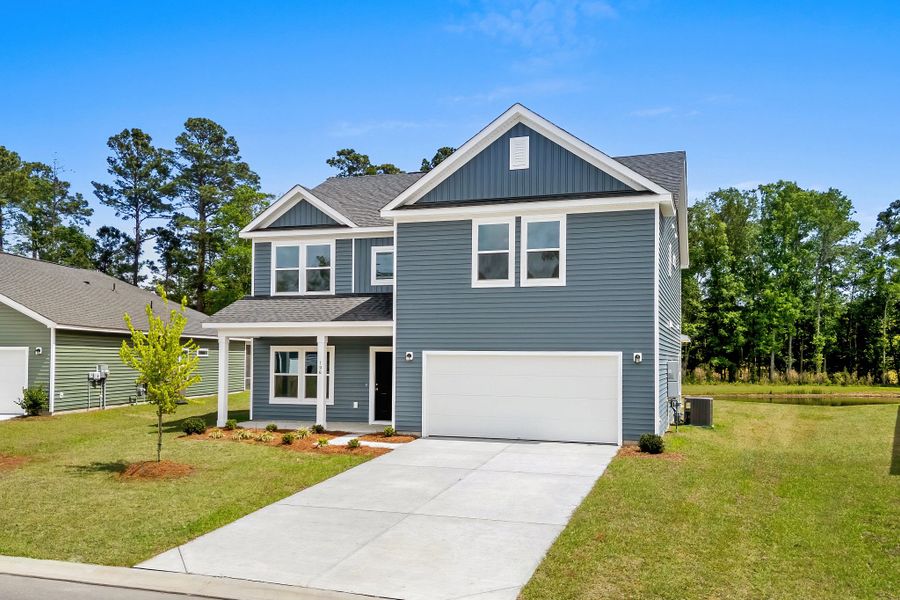 Front exterior of a new home in Trieste at Bella Vita, Myrtle Beach, SC, highlighting curb appeal (Image 2). Front exterior of a new home in Trieste at Bella Vita, Myrtle Beach, SC, highlighting curb appeal (Image 2).