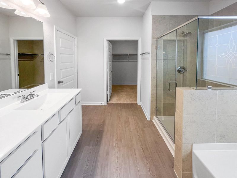 The Waring III- Primary Bathroom with Dual Vanities, Separate Garden tub and Walk-in Shower. Sample image for illustration; upgrades, options, and colors may vary.