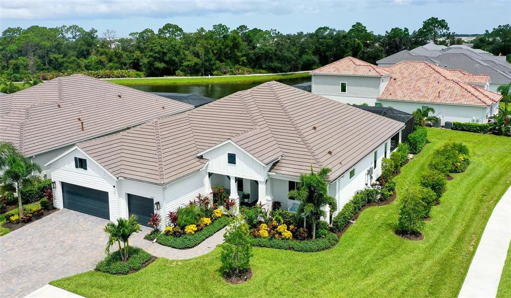 Front exterior of a new home in Windward, Lakewood Ranch, FL, highlighting curb appeal (Image 1). Front exterior of a new home in Windward, Lakewood Ranch, FL, highlighting curb appeal (Image 1).
