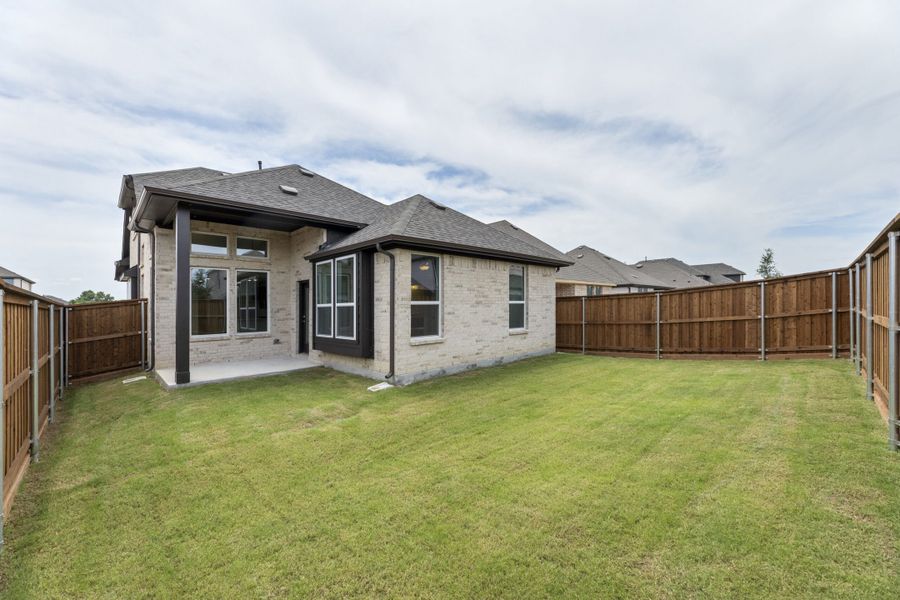 Exterior details and patio area of a home in The Reserve at Spiritas Ranch, Little Elm (Image 4).