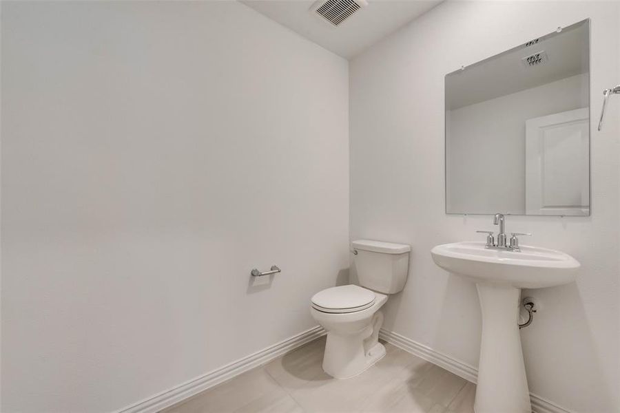 Bathroom with tile patterned flooring and toilet