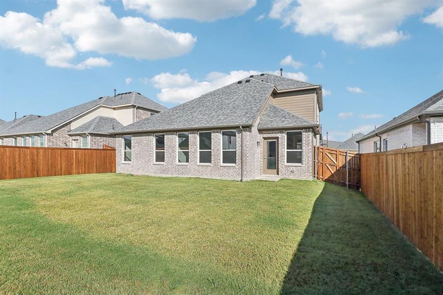 Rear view of house with a lawn