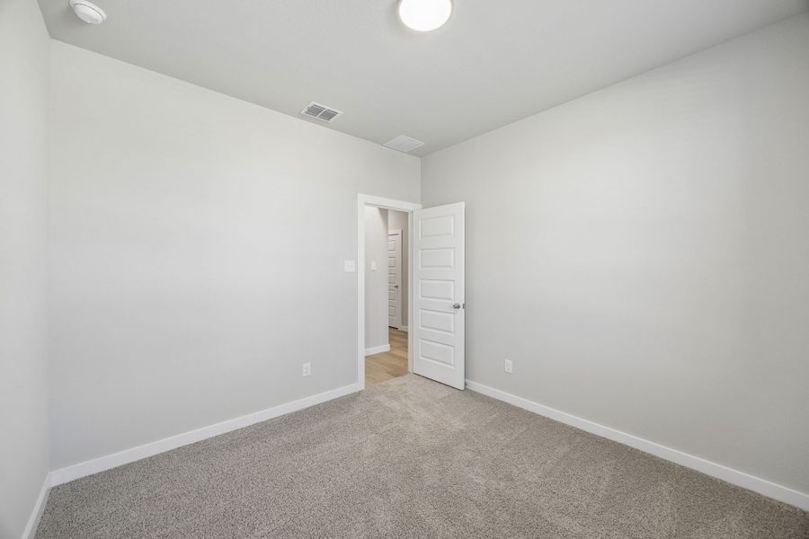 Bedroom in the Emmy II home plan by Trophy Signature Homes - REPRESENTATIVE PHOTO