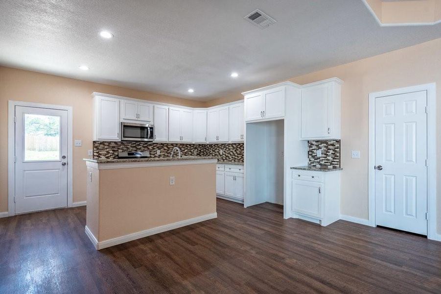 Kitchen with island provides great prep space.