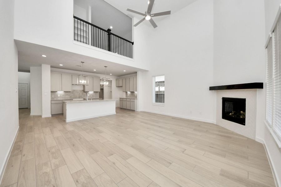 Take another glimpse into the heart of the home with this additional view of the family room—a sprawling space ready to accommodate all your gatherings. Sample photo of completed home with similar floor plan. Actual colors and selections may vary.