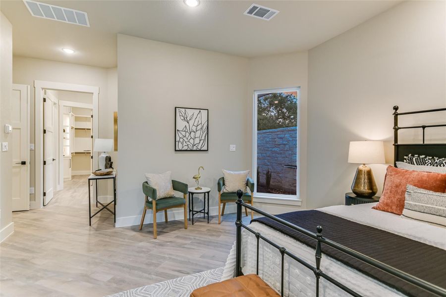 Bedroom featuring wood finished floors, a walk in closet, and recessed lighting Bedroom featuring wood finished floors, a walk in closet, and recessed lighting