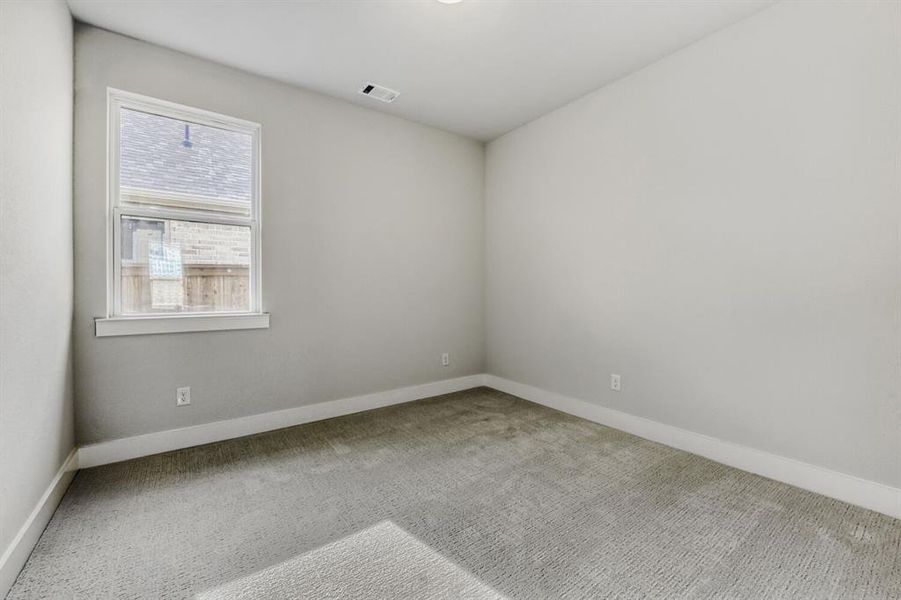 Spare room with carpet floors and baseboards