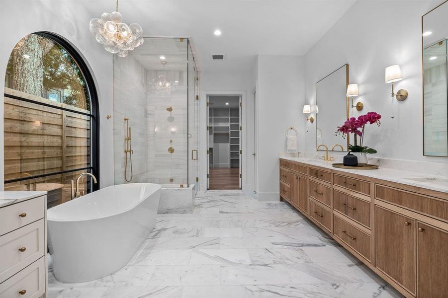 Luxurious primary bath with abundant natural light and designer finishes