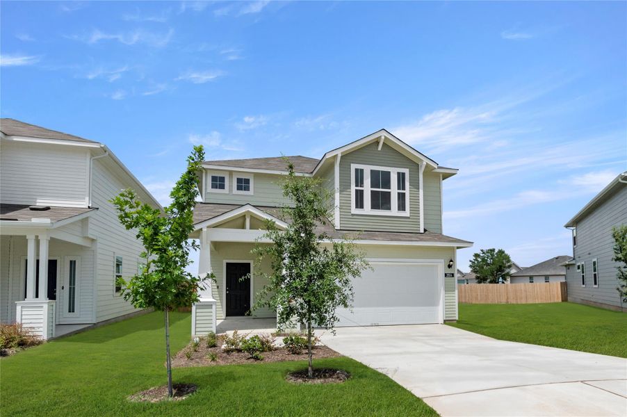 View of front of house with driveway, a garage, and a shingled roof