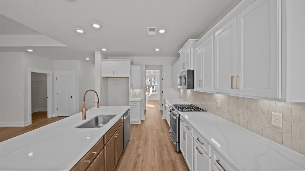 Exclusive kitchen design with large island and tasteful finishes throughout Exclusive kitchen design with large island and tasteful finishes throughout