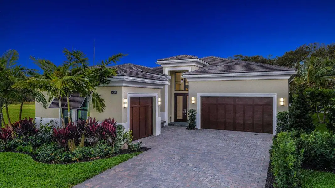 Front exterior of a new home in Artistry Palm Beach, Palm Beach Gardens, FL, highlighting curb appeal (Image 1).