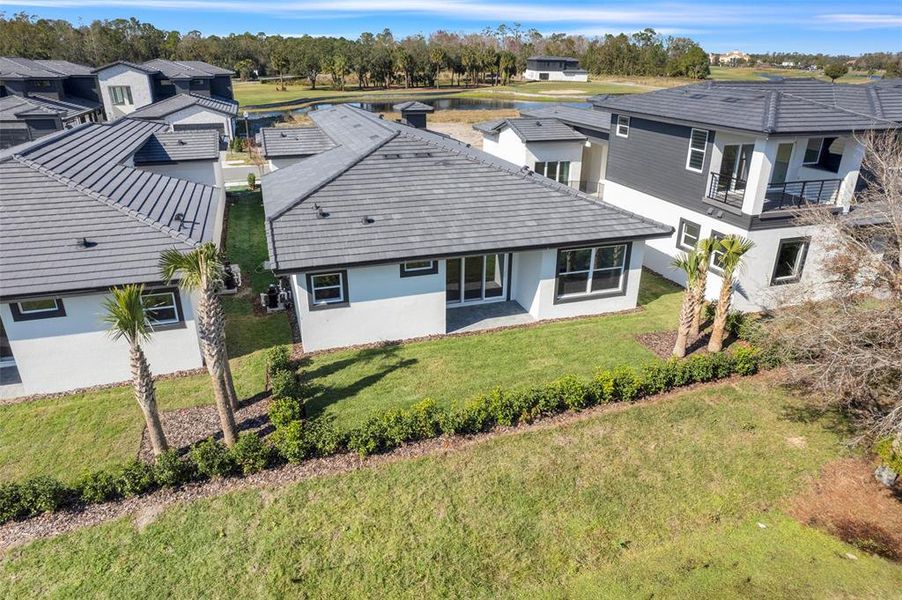 Exterior details and patio area of a home in Hampton Green at Providence, Davenport (Image 34).