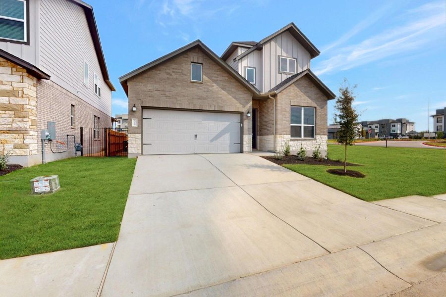 Front exterior of a new home in Estancia West, Manchaca, TX, highlighting curb appeal (Image 1).