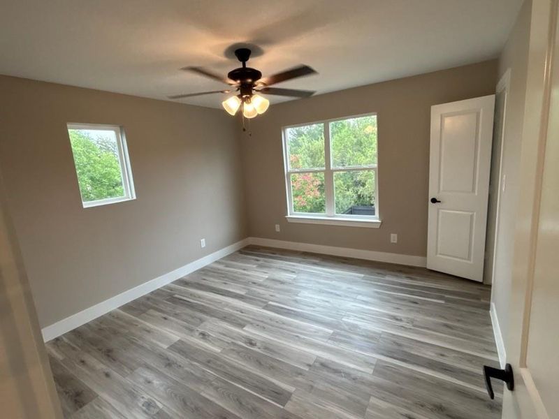 Unfurnished room featuring light wood finished floors and ceiling fan Unfurnished room featuring light wood finished floors and ceiling fan