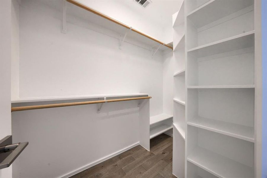 Second primary bedroom closet with extensive built-in shelving.