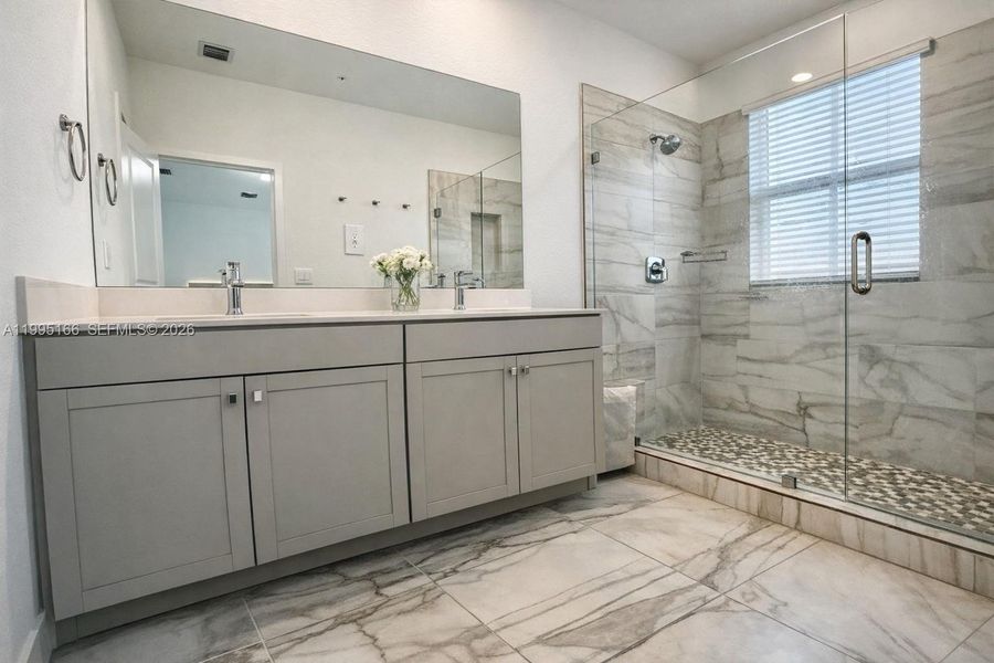 Modern primary bathroom with clean finishes and functionality Modern primary bathroom with clean finishes and functionality