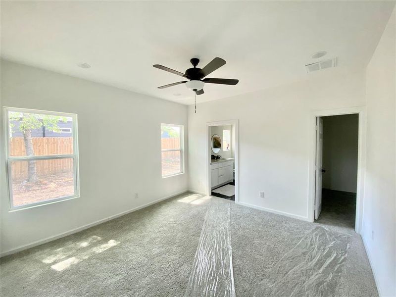 Empty room with carpet and ceiling fan