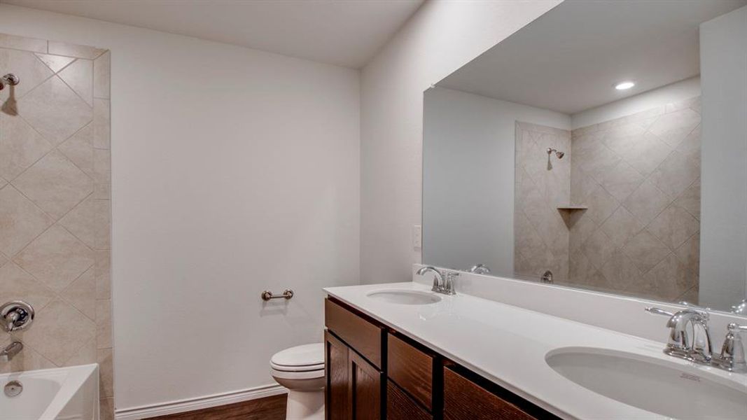 Full bath featuring double vanity, tub / shower combination, and recessed lighting Full bath featuring double vanity, tub / shower combination, and recessed lighting