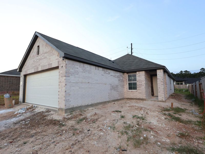 Front exterior of a new home in Magnolia Ridge, Magnolia, TX, highlighting curb appeal (Image 13). Front exterior of a new home in Magnolia Ridge, Magnolia, TX, highlighting curb appeal (Image 13).