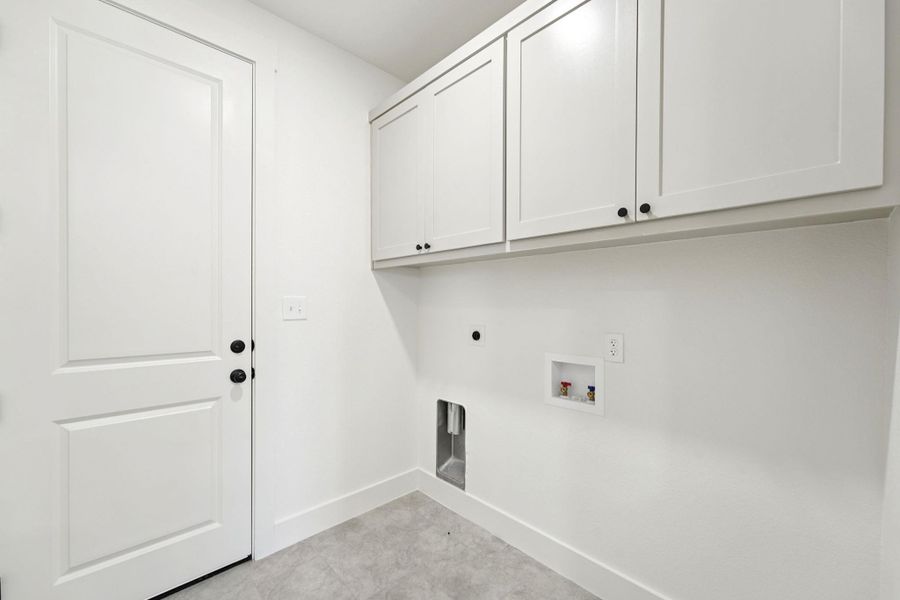 Washroom featuring hookup for a washing machine, hookup for an electric dryer, and cabinet space