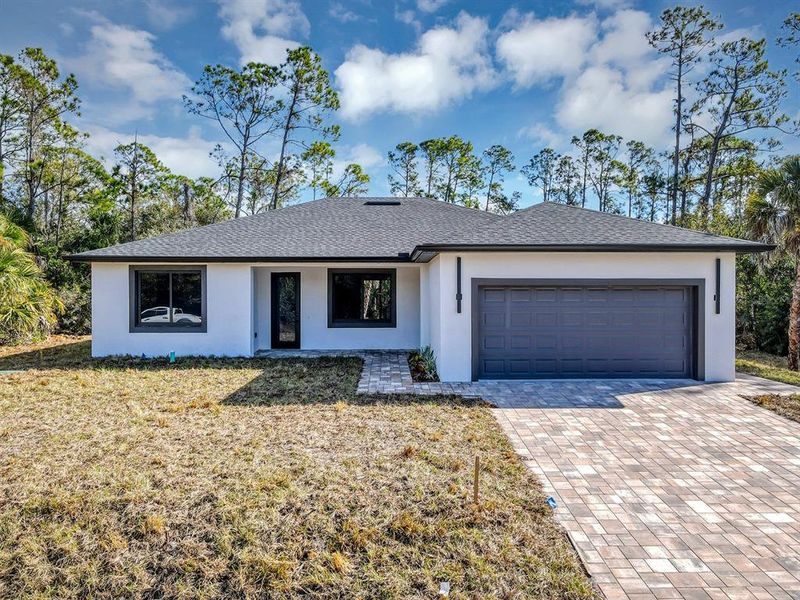 Front exterior of a new home in , Port Charlotte, FL, highlighting curb appeal (Image 2). Front exterior of a new home in , Port Charlotte, FL, highlighting curb appeal (Image 2).