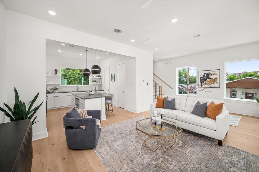 The expansive open living space is filled with natural light and flows effortlessly into the kitchen, creating the perfect setting for entertaining and everyday living.