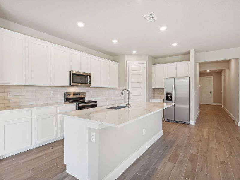 Kitchen in the Emilia floorplan at 8993 Dahlia Circle