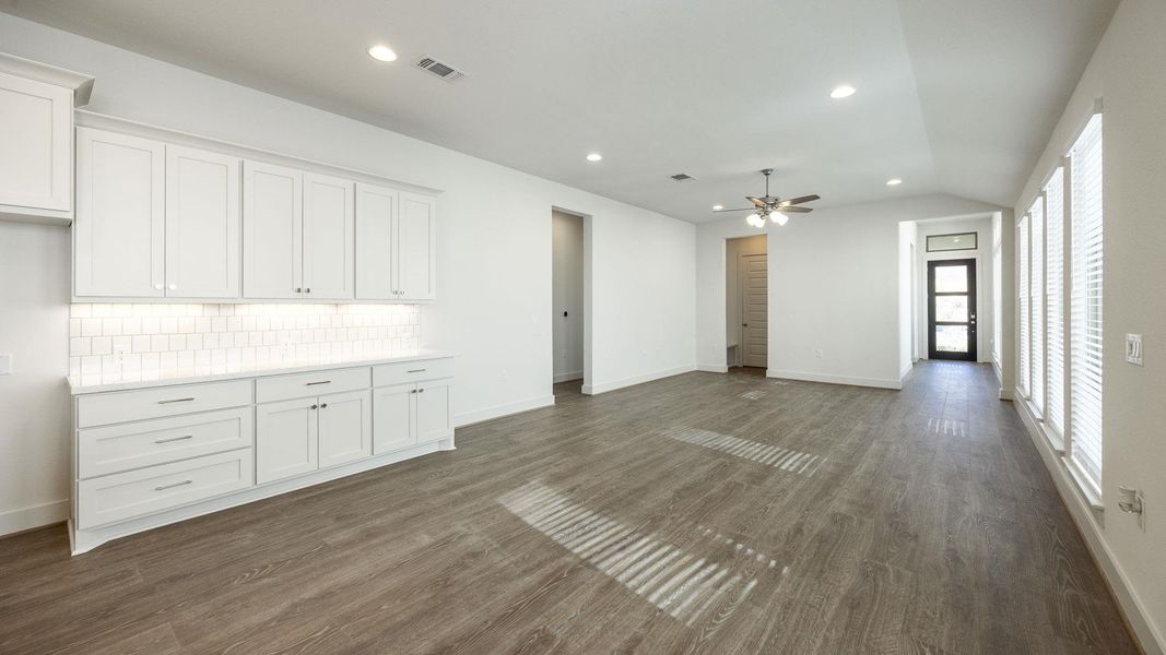 Unfurnished living room with recessed lighting, dark wood finished floors, lofted ceiling, and ceiling fan Unfurnished living room with recessed lighting, dark wood finished floors, lofted ceiling, and ceiling fan