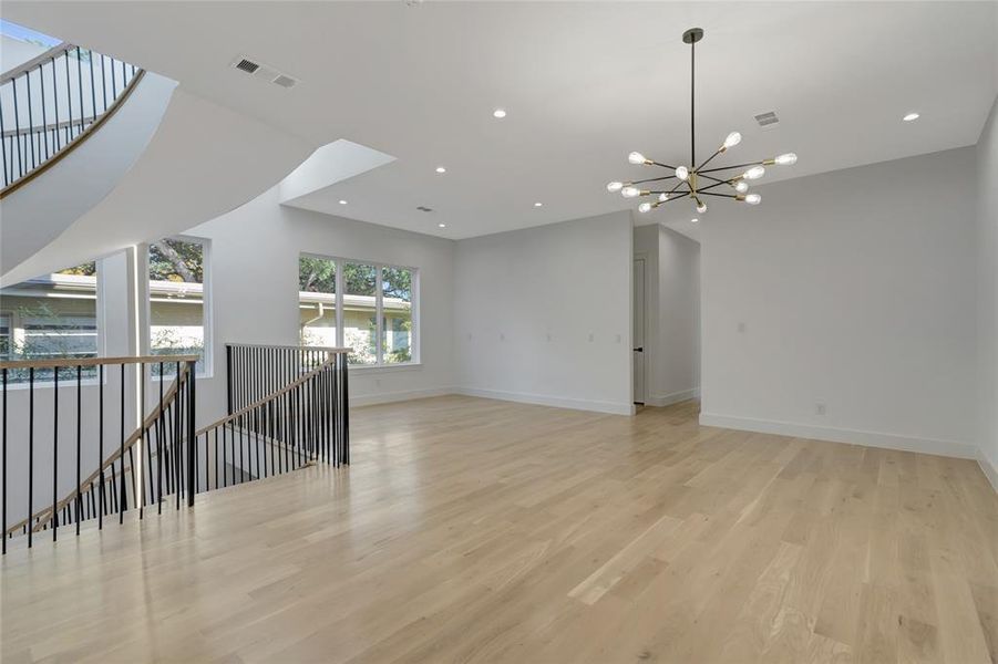 Game room with a chandelier and light hardwood / wood-style flooring