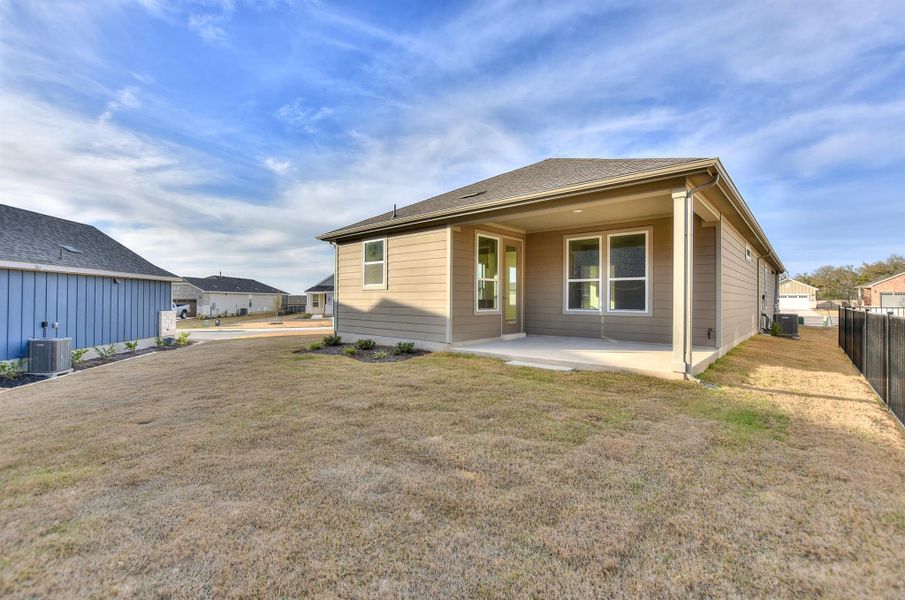 Back of house featuring central air condition unit, a yard, a patio area, and fence