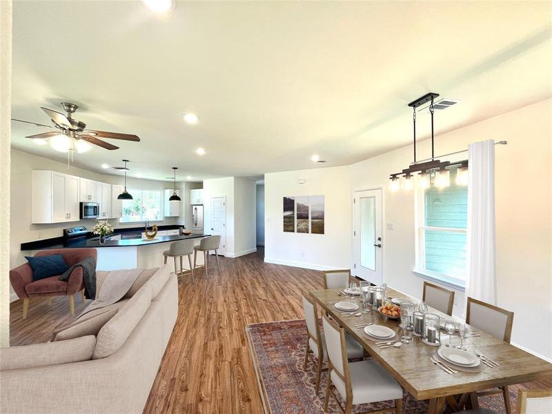 Dining room with light hardwood / wood-style flooring and ceiling fan