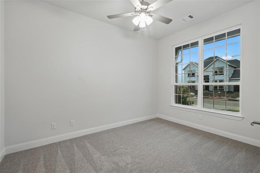 Unfurnished room with carpet, baseboards, and ceiling fan