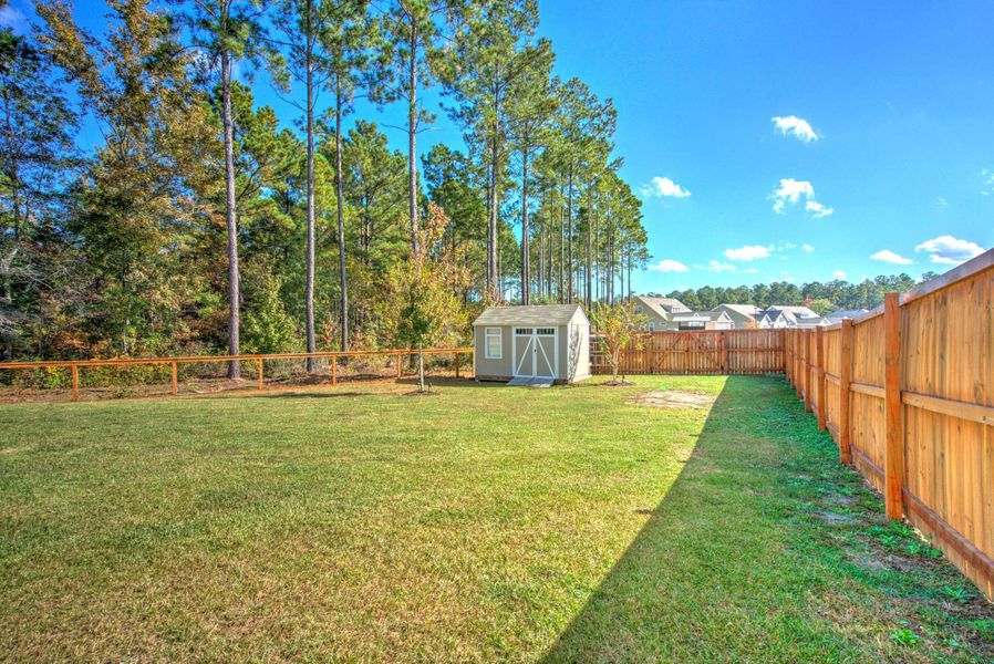 Exterior details and patio area of a home in French Quarter Creek, Huger (Image 27).