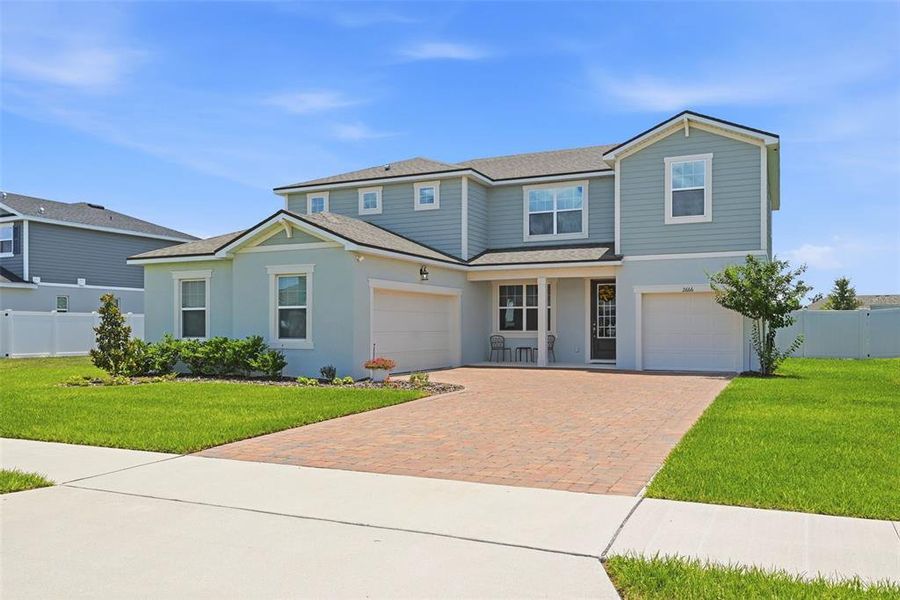 Front exterior of a new home in Meadowlark Landing, Apopka, FL, highlighting curb appeal (Image 2). Front exterior of a new home in Meadowlark Landing, Apopka, FL, highlighting curb appeal (Image 2).