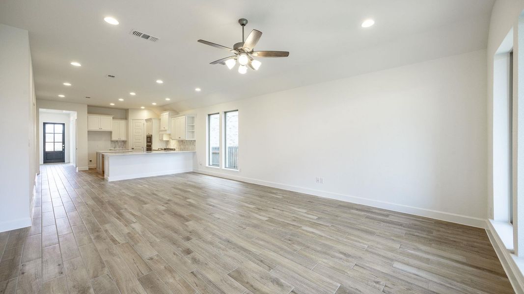 Unfurnished living room featuring recessed lighting, light wood-style flooring, and ceiling fan