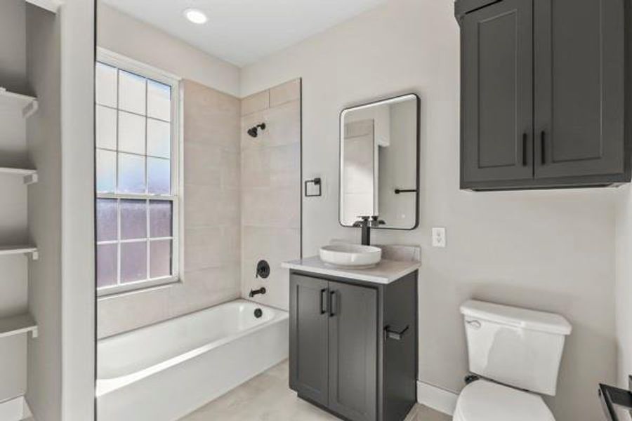 Full bathroom featuring washtub / shower combination and vanity Full bathroom featuring washtub / shower combination and vanity