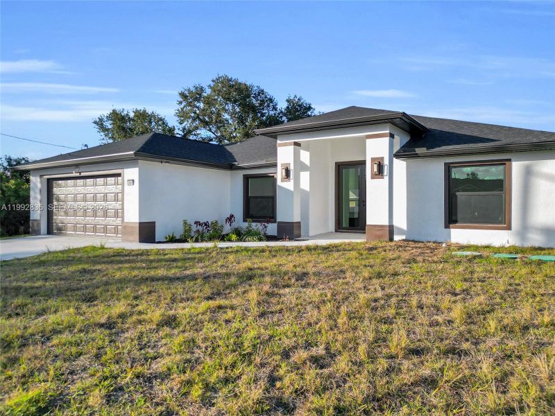 Front exterior of a new home in , Lehigh Acres, FL, highlighting curb appeal (Image 20).