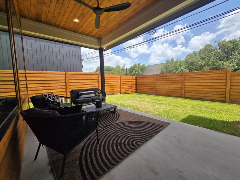 Back covered porch with lighting, and a ceiling fan to ward off any bugs in the evening or provide a breeze on hot summer days.
