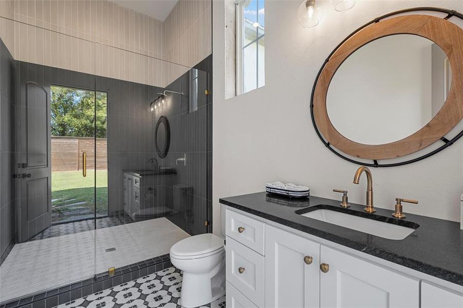 Full bathroom featuring plenty of natural light, vanity, and a shower stall