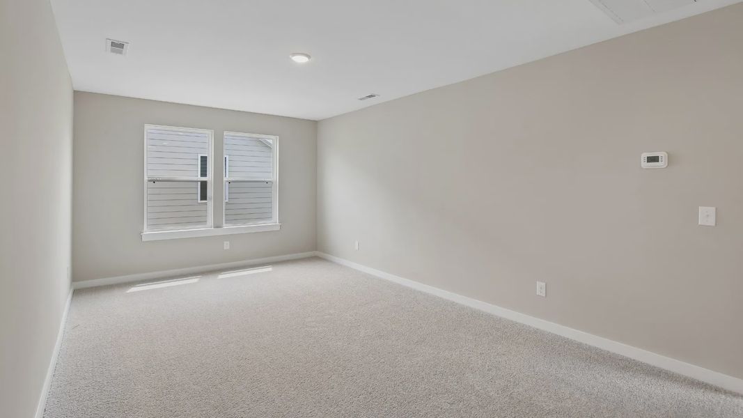 Second Floor Loft area with windows and carpet Second Floor Loft area with windows and carpet