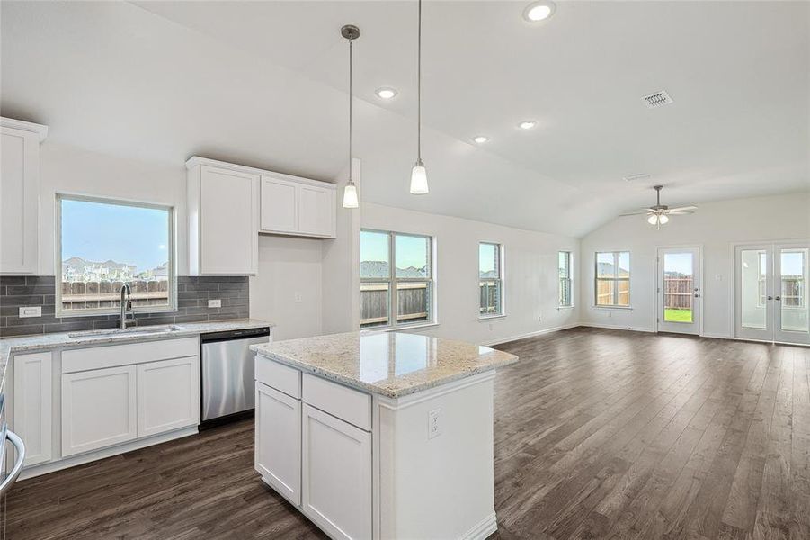 Kitchen with stainless steel dishwasher, ceiling fan, and white cabinets