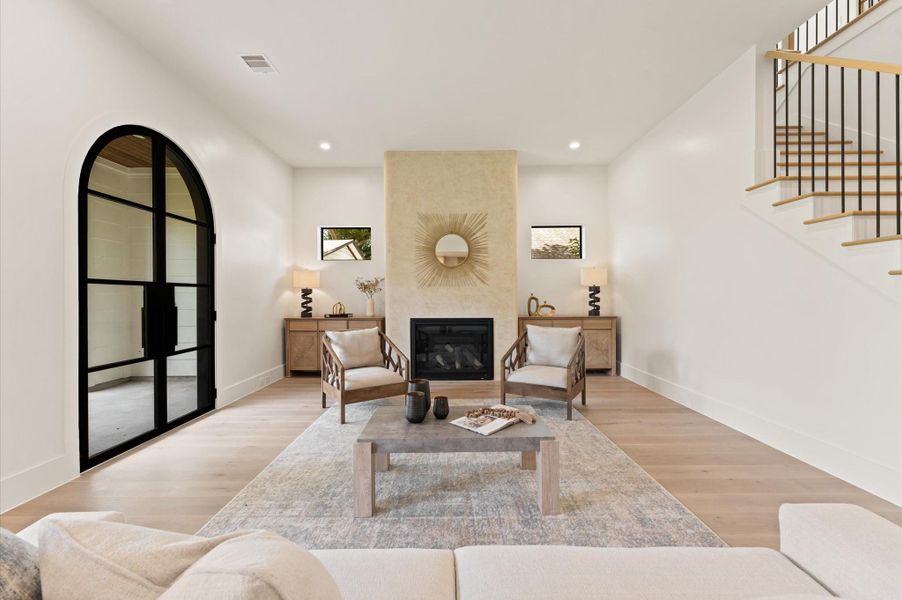 Expansive living room has curved plaster fireplace, a striking focal point that adds an artistic element to the space. Expansive living room has curved plaster fireplace, a striking focal point that adds an artistic element to the space.