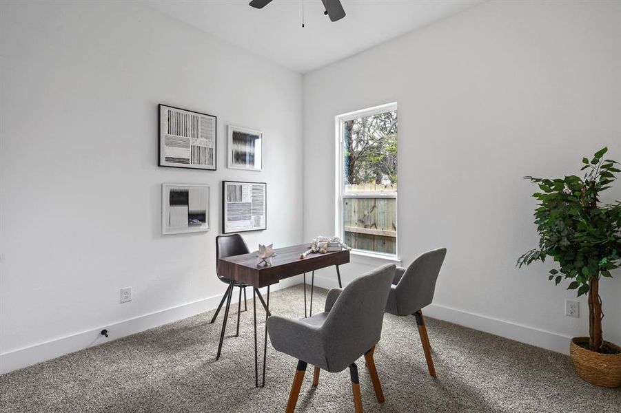 Office space featuring ceiling fan and carpet