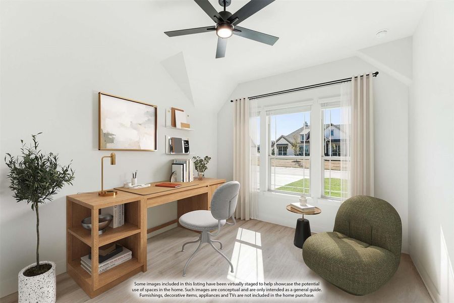 Home office with vaulted ceiling, wood desk, ceiling fan, and large window with natural light