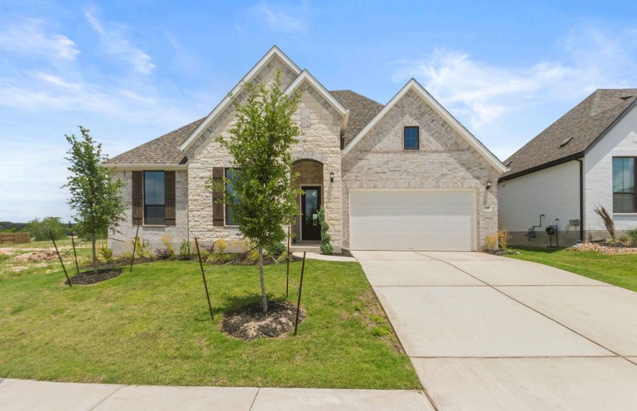 Front exterior of a new home in 6 Creeks, Kyle, TX, highlighting curb appeal (Image 31). Front exterior of a new home in 6 Creeks, Kyle, TX, highlighting curb appeal (Image 31).