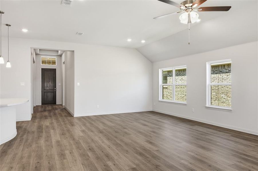 Spare room featuring ceiling fan, recessed lighting, vaulted ceiling, and dark wood finished floors