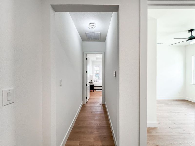Hallway with wood finished floors and baseboards